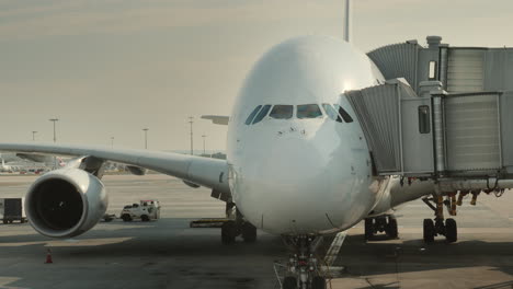 passengers board a huge airliner at the hub visible silhouettes of people entering the plane