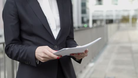 cropped shot of businesswoman holding papers