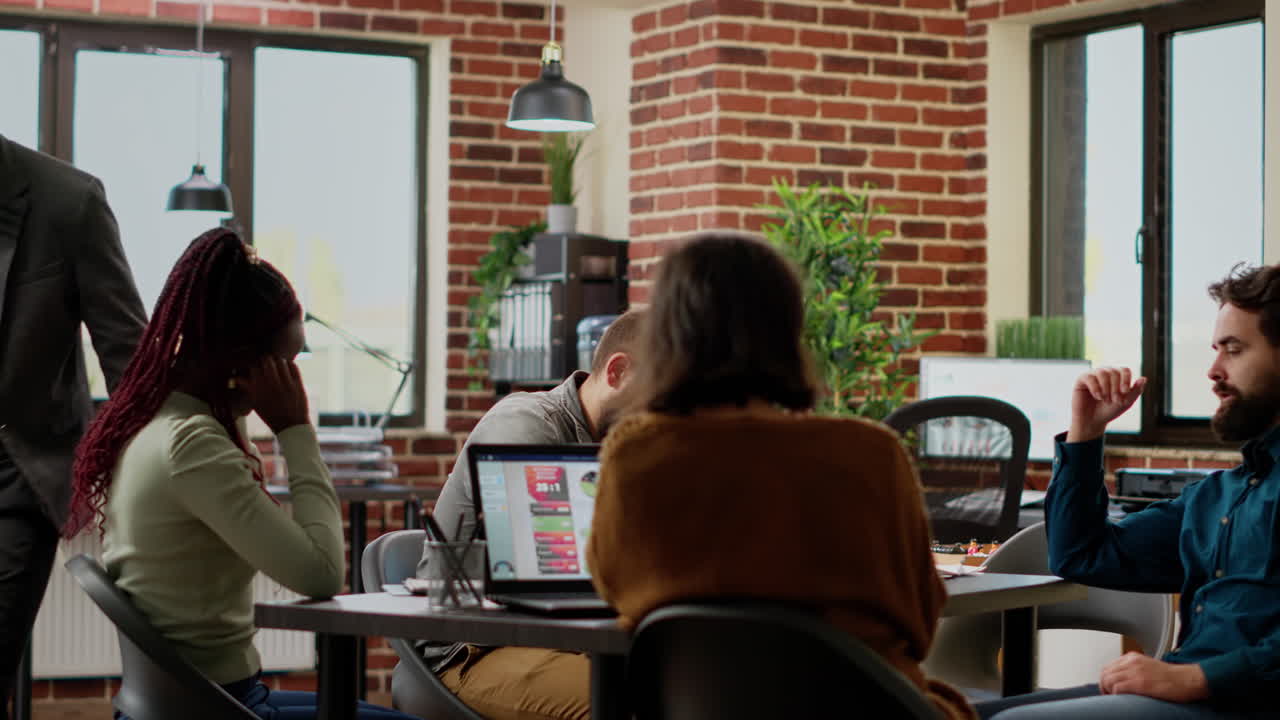 Furious angry boss throwing documents on table at colleagues