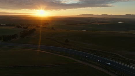 3 pickup trucks driving on a beautiful road through lush green nature in the western cape