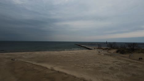 waves crashing against a sandy shoreline in mid winter