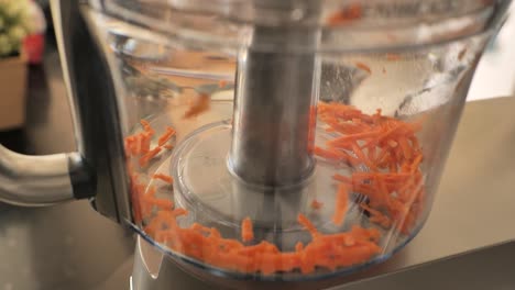 close-up of carrots being chopped in a food processor