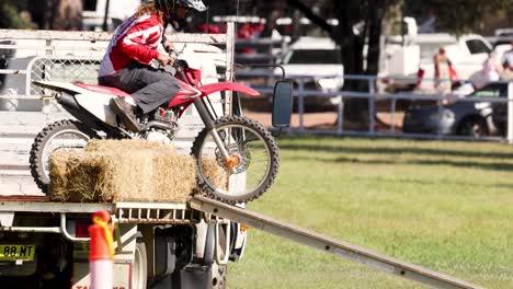 motorcyclist executing stunts over obstacles