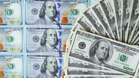 some dollars are rotating. background of money. american cash turning round on one hundred dollars background. beautiful rich background with 100 dollar bills.