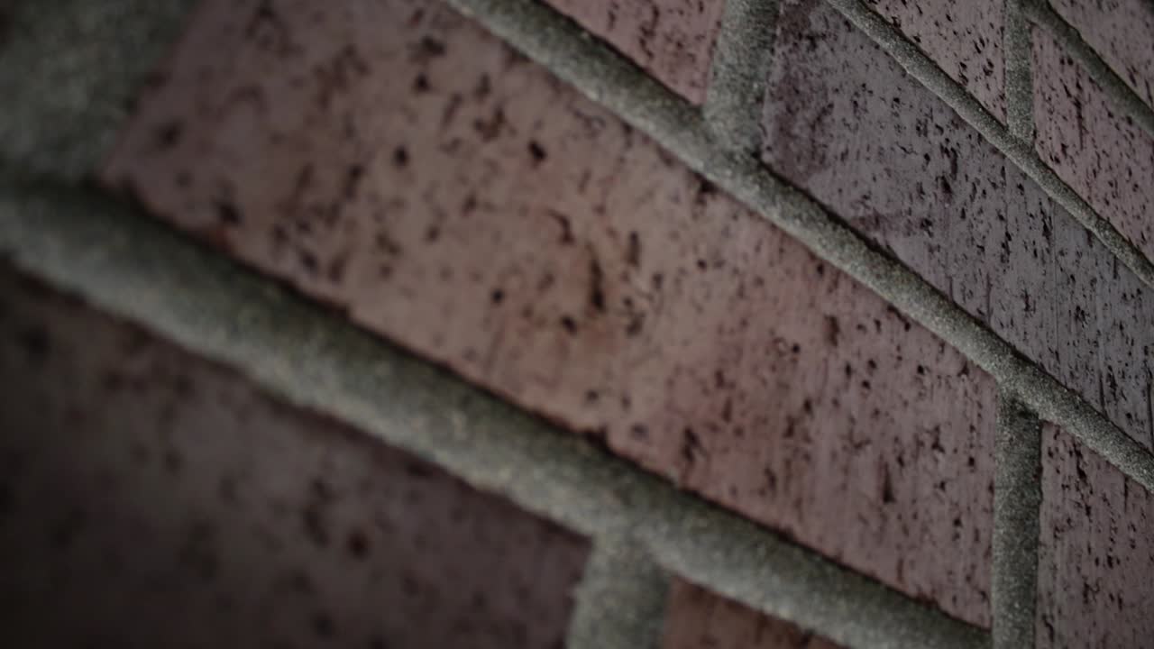 Slow Motion steam vent on brick building rack focus