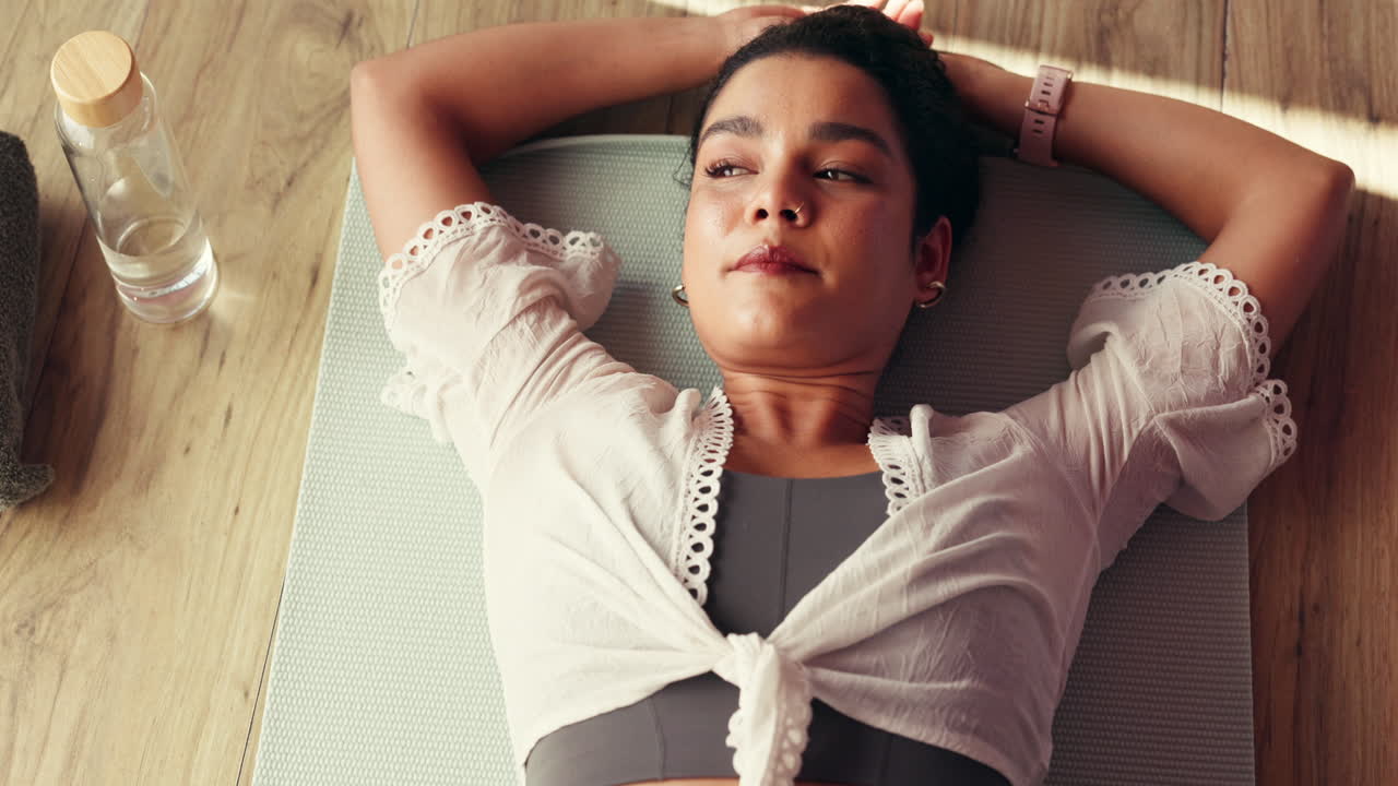 Woman Resting on Yoga Mat After Exercise