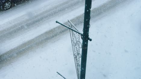 top view of car passing in slow motion during cold winter snow blizzard