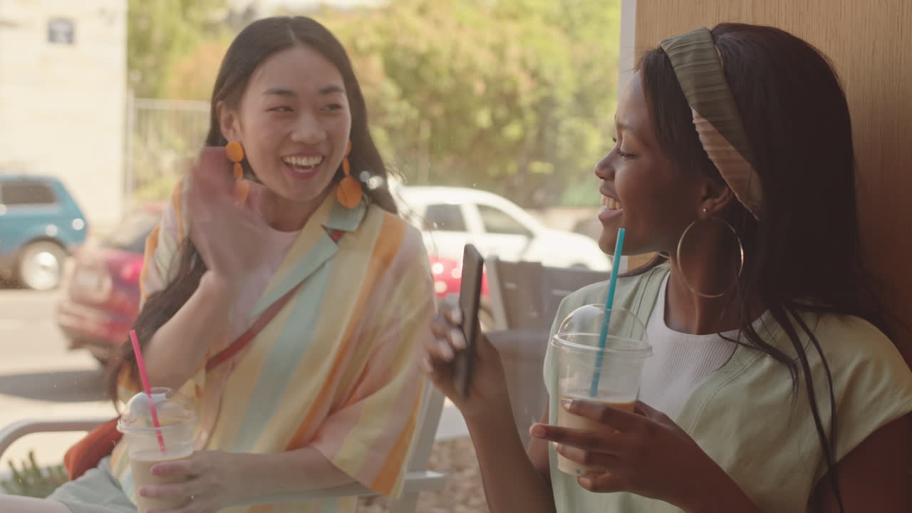 Cheerful Girlfriends Meeting in Cafe