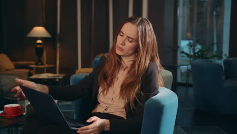 Fatigue-woman-working-laptop-in-hotel-lobby-at-evening.-Tired-business-woman