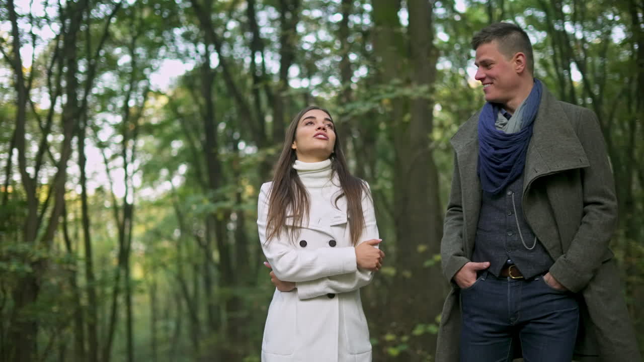 Couple walking in woods during fall