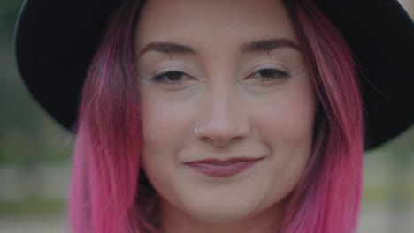 young woman with pink hair and hat