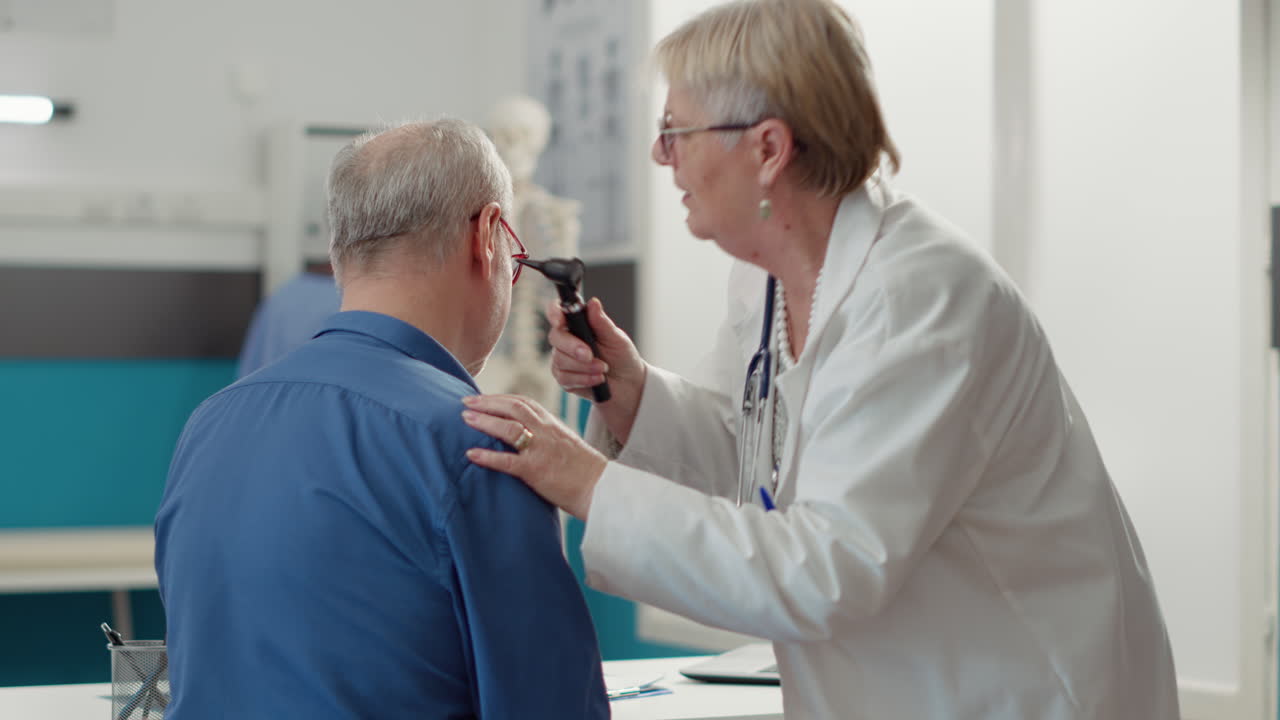 Otolaryngology specialist using otoscope to examine ear infection