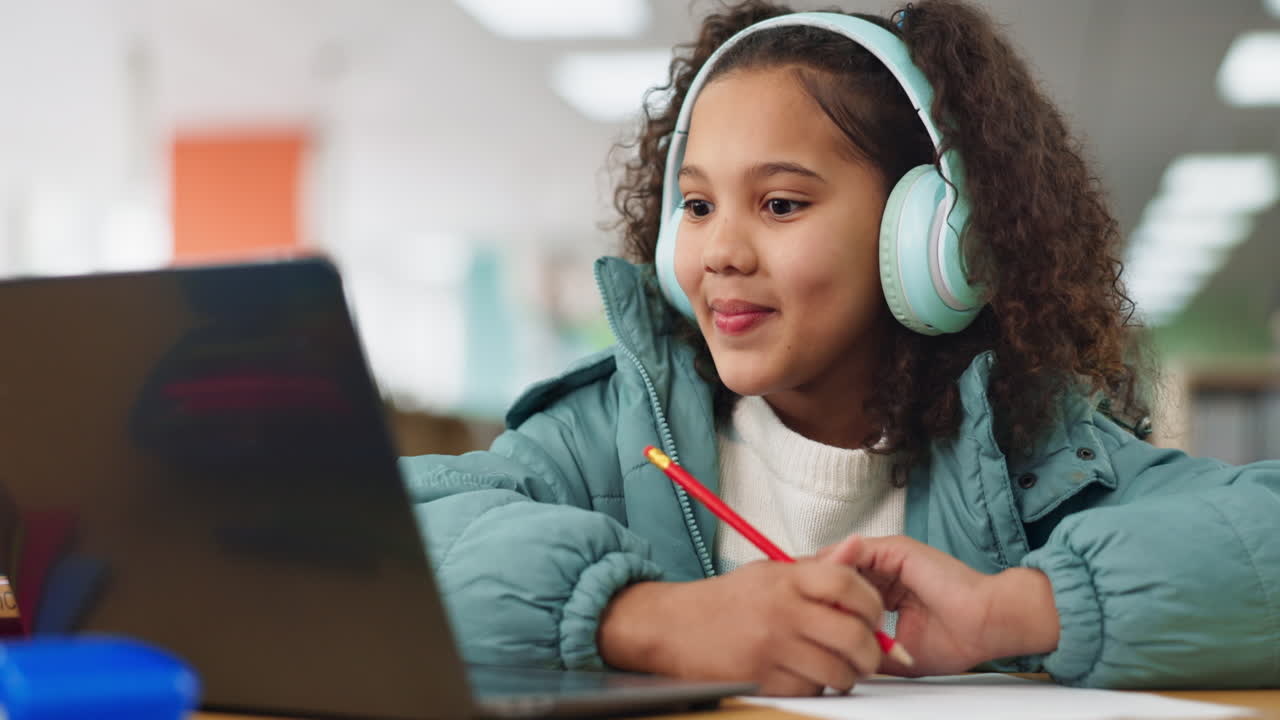 Girl studying with laptop and headphones