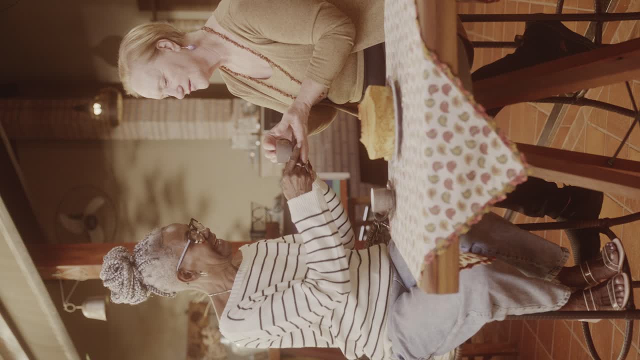 Two elderly women socializing and enjoying coffee in a cafe