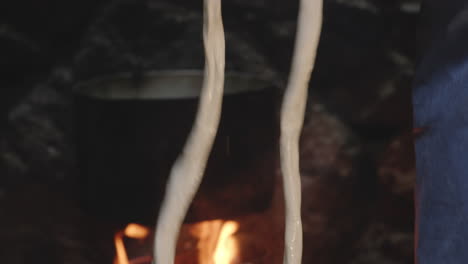 hands forming tenili cheese into string,chobareti, georgia, tilt down