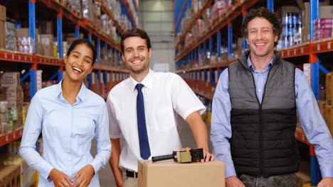 warehouse workers looking to the camera together