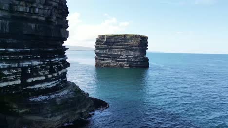 low drone shot flying towards downpatrick head