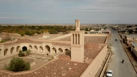 fly around the wind catcher ancient historical building caravansary in desert city oasis use for air circulation passive architectural design with adobe mud brick old city building hoses