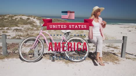 Animation-of-american-flag,-united-states-of-america-independent-since-1776-text,-woman-on-beach