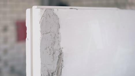 painter hand holds special metal equipment and smears wall