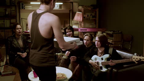 musical group sitting on sofa on studio