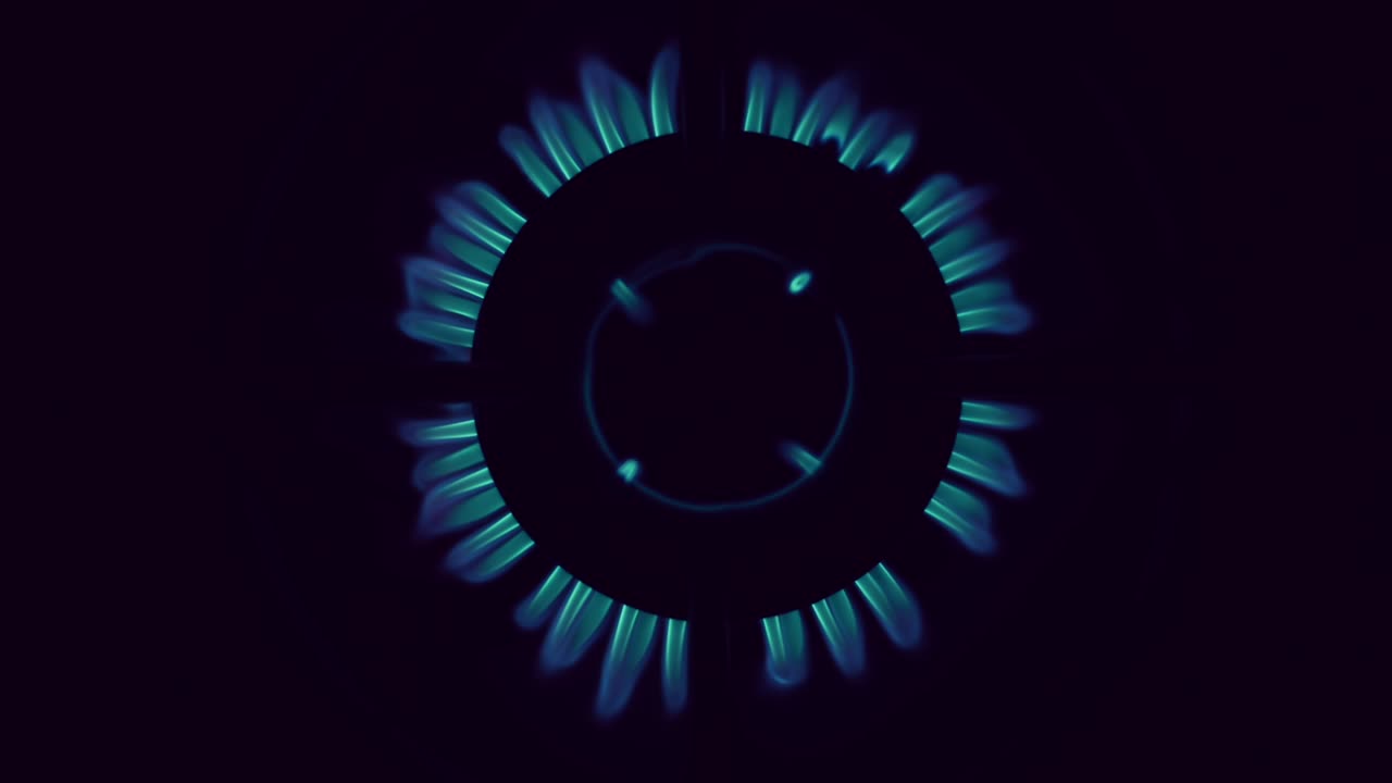 Top view on gas stove burner gas blue flame