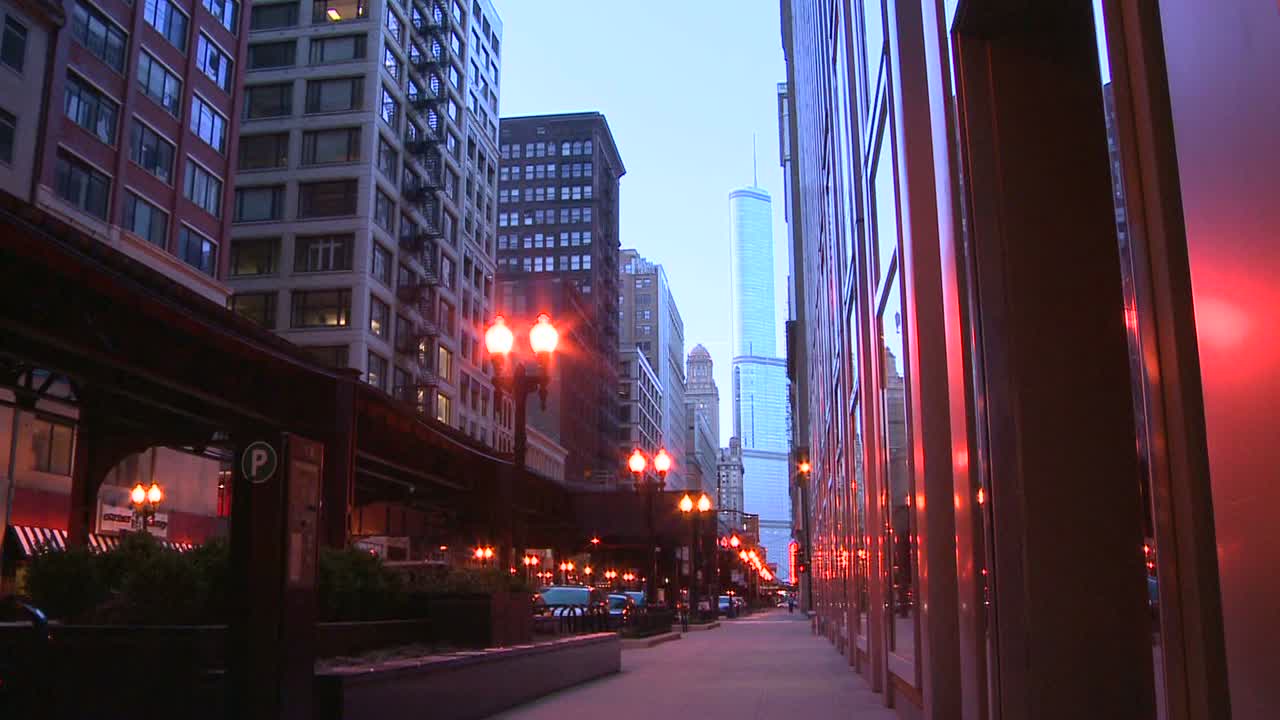 el 기차는 시카고 다운타운의 황혼에 높은 플랫폼을 통과합니다.