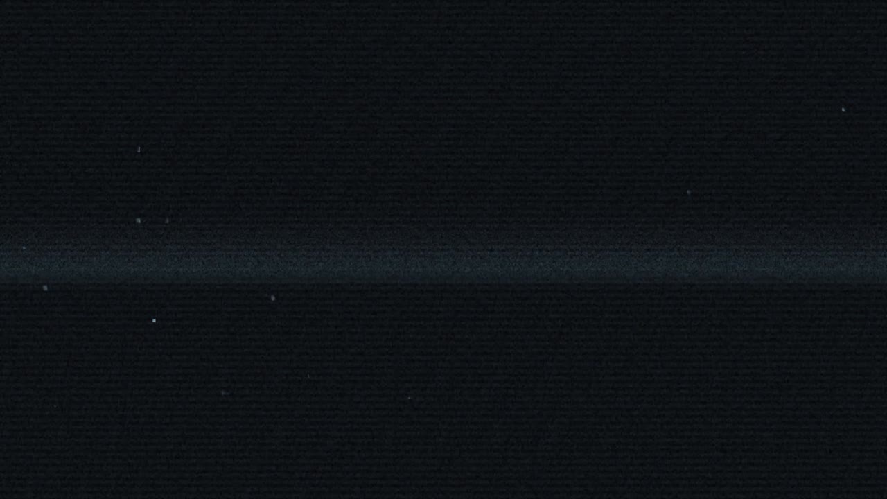 Authentic vhs tape noise with subtle static, glitches, and a dark, faded screen with scan lines. Perfect overlay for creating a retro 80s or 90s look