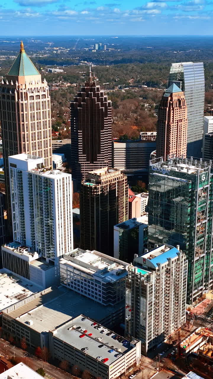 Beautiful skyscrapers in the city downtown. Aerial view on the high-rise buildings on sunny weather. Vertical video