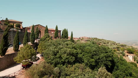 Flying-Towards-Historic-Town-On-A-Summer-Breeze-In-Montalcino,-Tuscany,-Italy