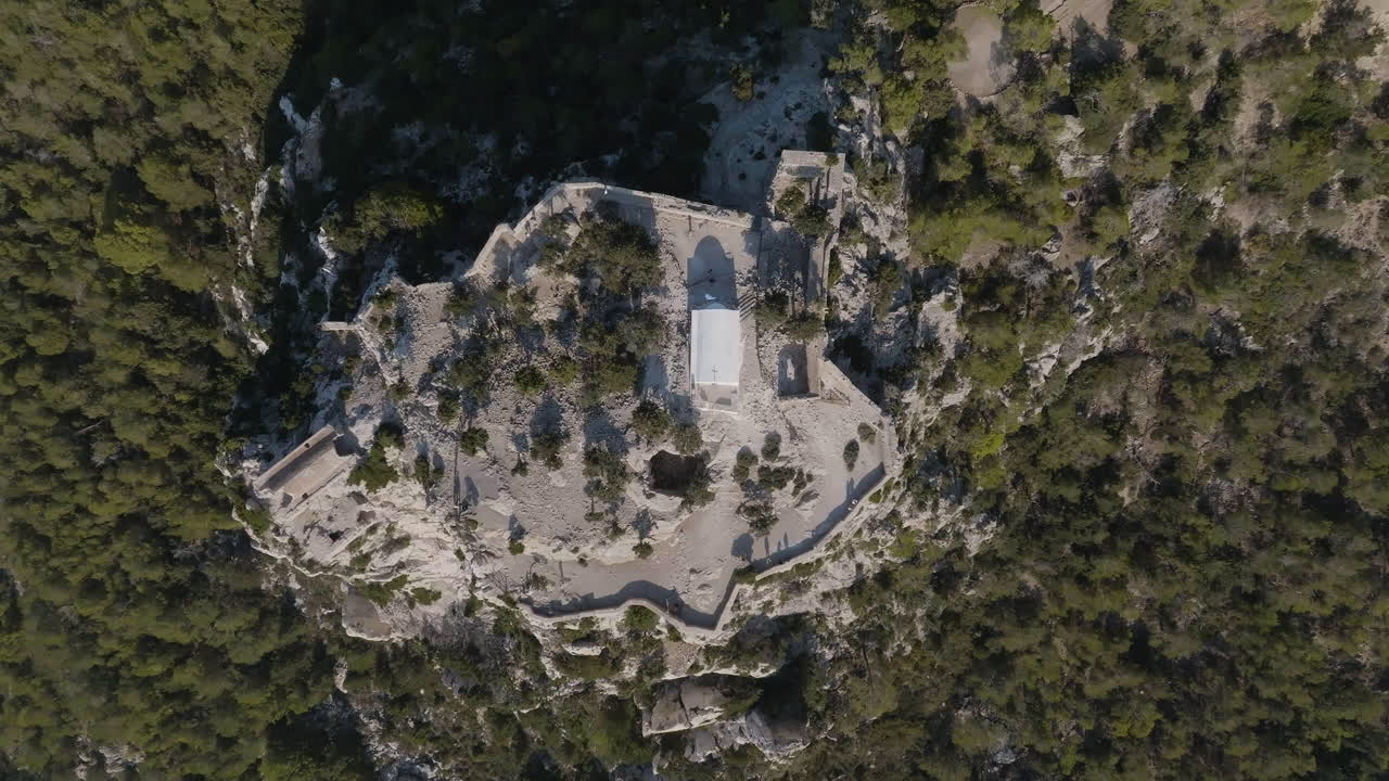 Birds eye drone shot descending above the Castle of Monolithos, in sunny Rhodes