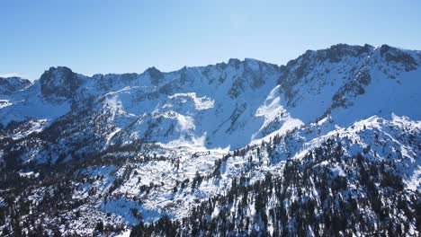 drone flying towards snowy mountains in mammoth lakes california