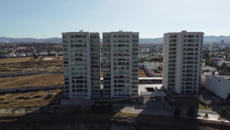 aerial approaching shot of modern residential area blocks in suburb of puebla city