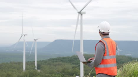 Progressive-concept-of-engineer-working-in-the-wind-farm-atop-of-the-mountain.