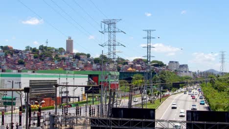 high above the highway’s roar, power lines hum, and cables soar