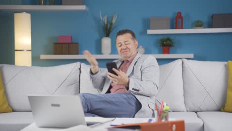 home office worker man getting good news on the phone.