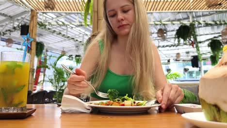 woman enjoying a healthy lunch at a tropical restaurant