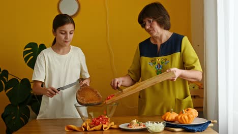 Grandmother-and-granddaughter-cooking-healthy-salad