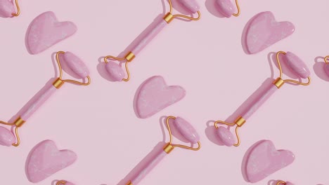 belleza facial de cuarzo rosa rodillo y masajeador para masaje de gua sha en fondo rosa. patrón. anti-envejecimiento, levantamiento y tratamiento de tonificación cuidado de la piel. productos cosméticos.