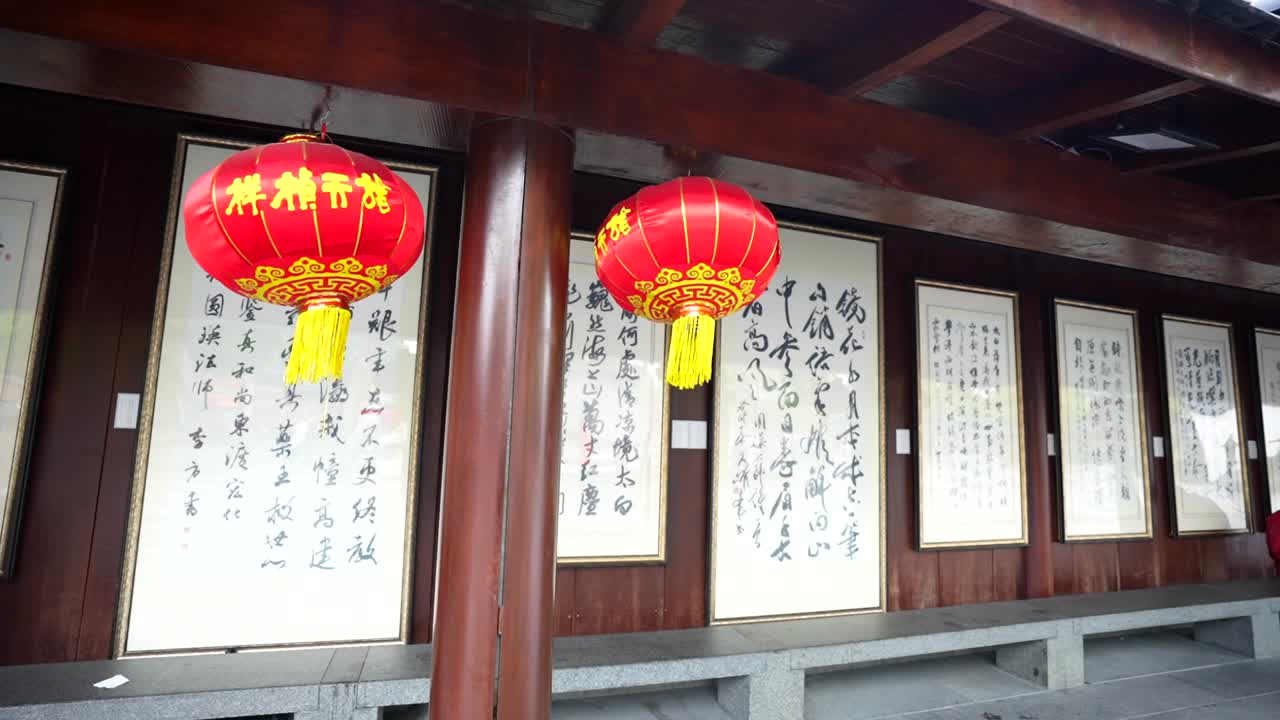 Slow motion view of red lanterns and white panels with information written in kanjis at Longhua Temple, Shanghai, China