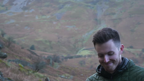 smiling man is happy to be in the mountains