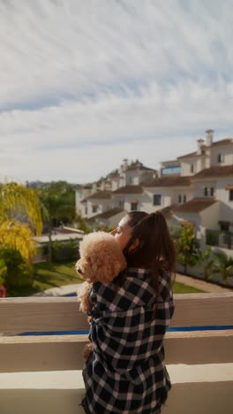 girl with her dog on a balcony enjoying the view