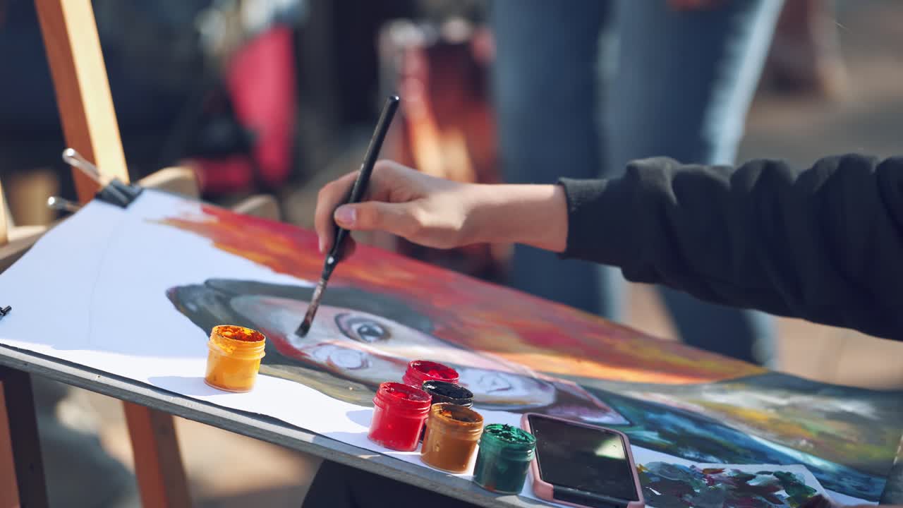 Artist working on painting outside. Artist painting scenery of urban landscape