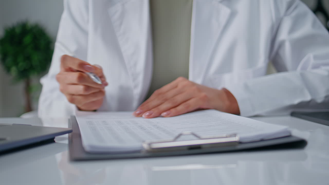 Doctor busy medical paperwork in healthcare facility closeup. Woman professional