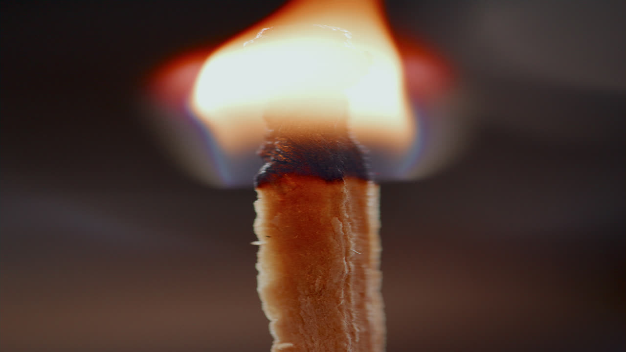 Vertical Close Up of Matchstick Burning with Bright Flame Leaving Charred Tip