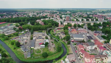 Drone-parallax-footage-of-a-whole-city-with-curved-river-during-festival