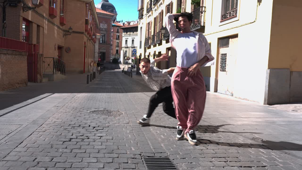 Dos jóvenes bailando danza contemporánea en una calle de la ciudad