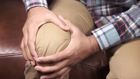 man holding his aching knee