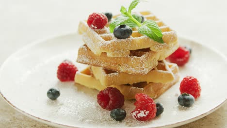 waffles served on plate with berries