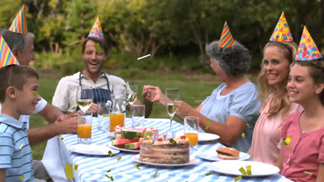 family group celebrating in backyard, showcasing marketing with animated cake icons and confetti